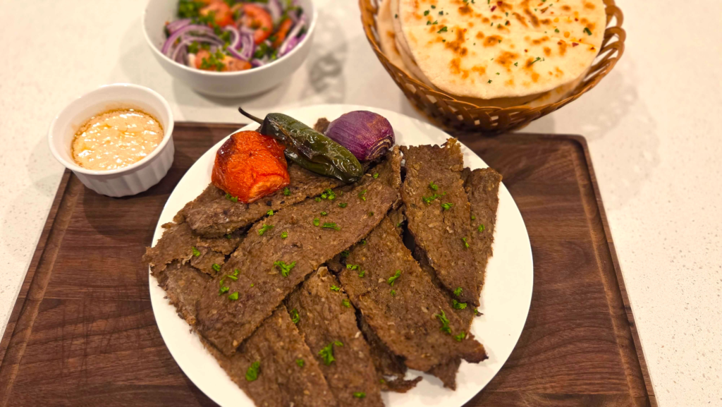 Homemade Turkish doner kebab made with seasoned beef, fresh salad, and flatbread