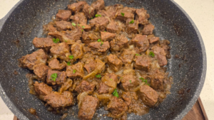 Kabab halla cooking in a Dutch oven with tender beef and onions