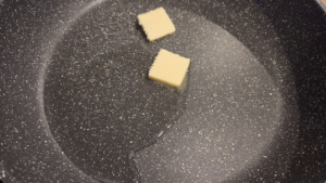Heating oil and butter in a pot while preparing kabab halla recipe