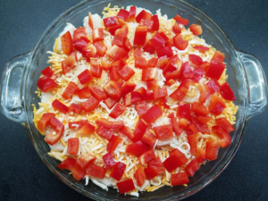 layering bread, cheese, and peppers for eggah