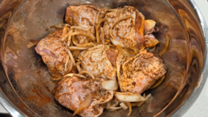 Chicken thighs coated in Middle Eastern yogurt marinade with onions and spices.