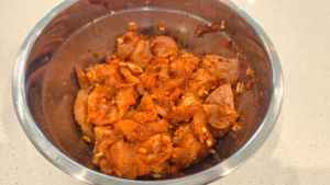 Chicken breast cubes marinating in spicy honey garlic Mediterranean marinade