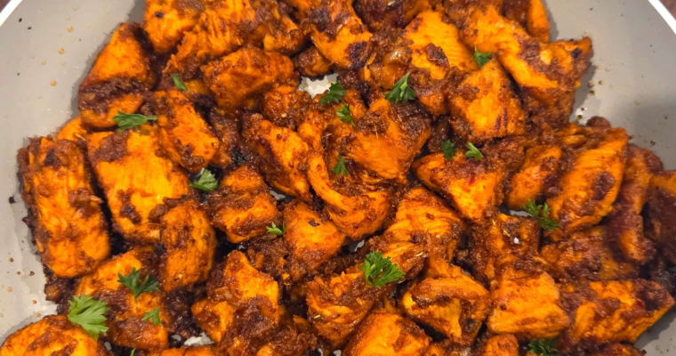Mediterranean spicy honey garlic chicken bites served over white rice with fresh parsley and Mediterranean salad