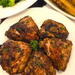 Juicy Middle Eastern grilled chicken thighs served with grilled corn and broccoli.