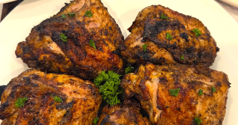 Juicy Middle Eastern grilled chicken thighs served with grilled corn and broccoli.