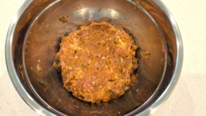 Mixing ground beef and spices together for homemade Turkish beef kofte
