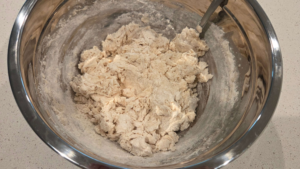 Mixing dough ingredients for soft Turkish flatbread recipe