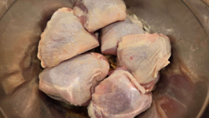 Raw chicken thighs for Middle Eastern grilled chicken.