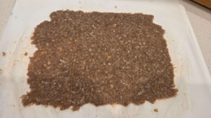 doner kebab meat rolled thinly on a parchment paper before baking