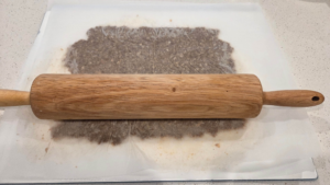 Seasoned doner kebab meat rolled thinly between parchment paper before baking