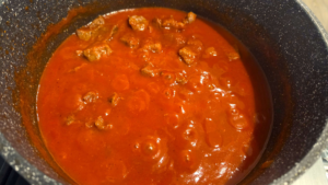 Egyptian beef stew simmering in rich tomato sauce