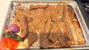 Thinly slicing homemade Turkish doner kebab after baking