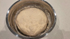 Turkish flatbread dough rising in a bowl until doubled in size
