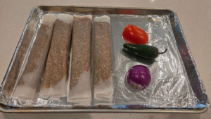 Raw homemade doner kebab wrapped in parchment paper ready for baking