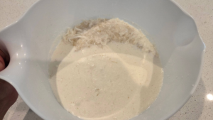 Adding plant-based milk and oil to the vegan basbousa batter