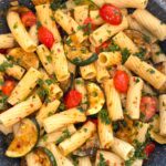 Easy zucchini and cherry tomato pasta recipe served with garlic, olive oil, and parsley.