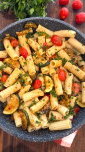Easy zucchini and cherry tomato pasta recipe served with garlic, olive oil, and parsley.