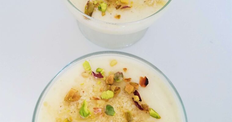 Egyptian mahalabia recipe served in a glass dessert bowl topped with pistachios