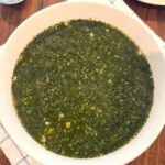 Authentic Egyptian molokhia recipe made with minced molokhia leaves, garlic, coriander, and chicken broth