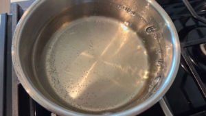Sugar and water are simmering to make syrup for vegan basbousa