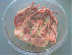 Mediterranean lamb chops are marinating in the refrigerator for maximum flavor