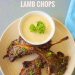 Mediterranean grilled lamb chops recipe served on a platter with fresh rosemary and parsley, served with tahini sauce