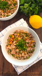 No Mayo Mediterranean Tuna Salad Recipe made with tuna, bell peppers, parsley, olive oil, and lemon juice in a serving bowl.