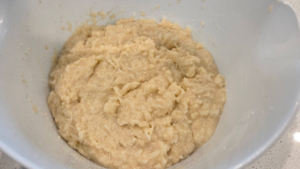 Mixing plant-based milk and oil into vegan basbousa batter.
