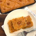 Vegan basbousa recipe topped with almonds and soaked in syrup, a traditional Egyptian semolina cake.