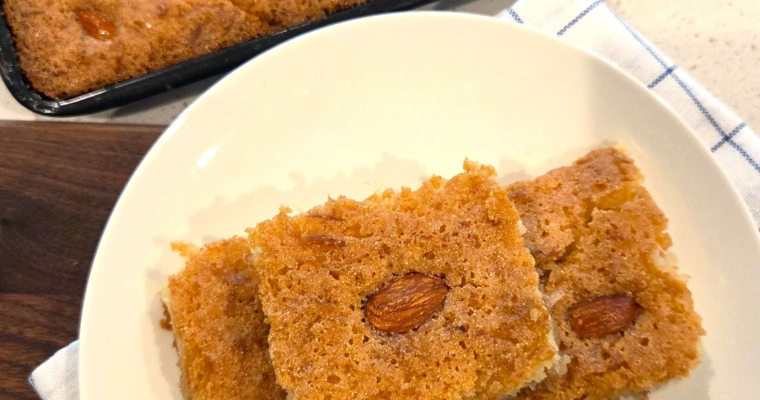 Vegan basbousa recipe topped with almonds and soaked in syrup, a traditional Egyptian semolina cake.