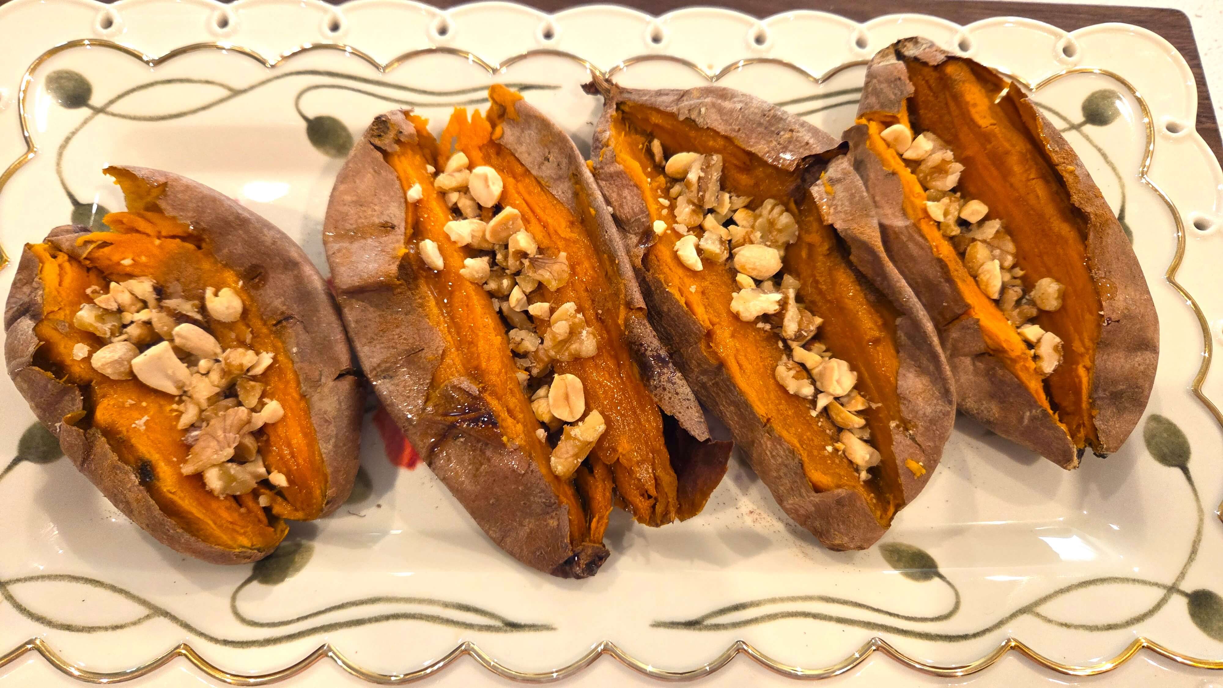 Drizzling honey over a baked sweet potato with cinnamon and chopped nuts before serving