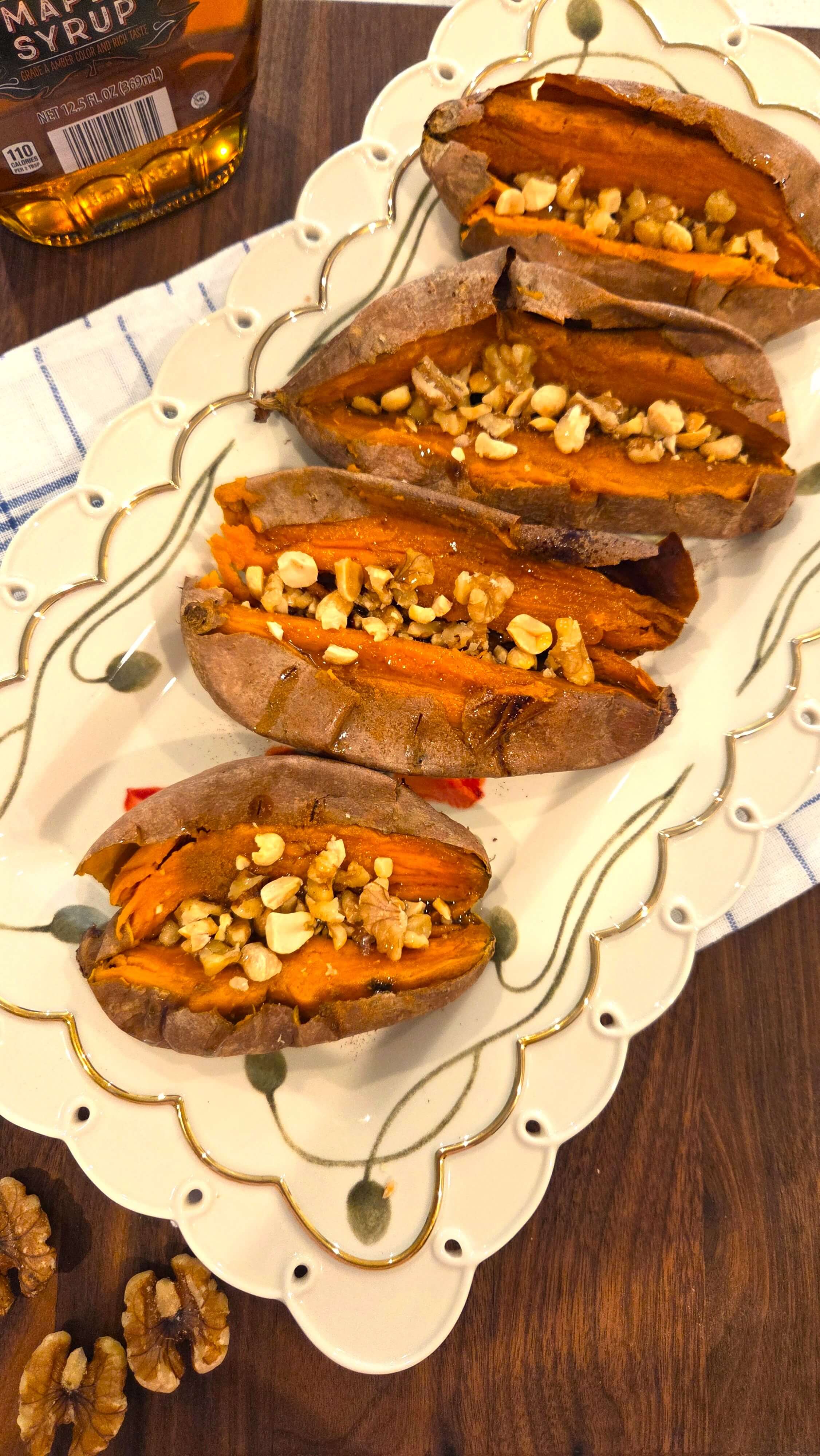 A beautiful close-up shot of an authentic plate of easy baked sweet potatoes highlighting the crispy skin and fluffy orange interior.