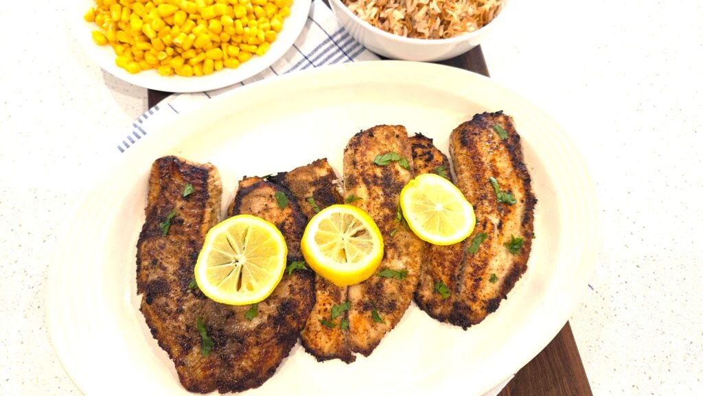 Mediterranean pan seared tilapia with a golden crust, fresh lemon, and parsley.