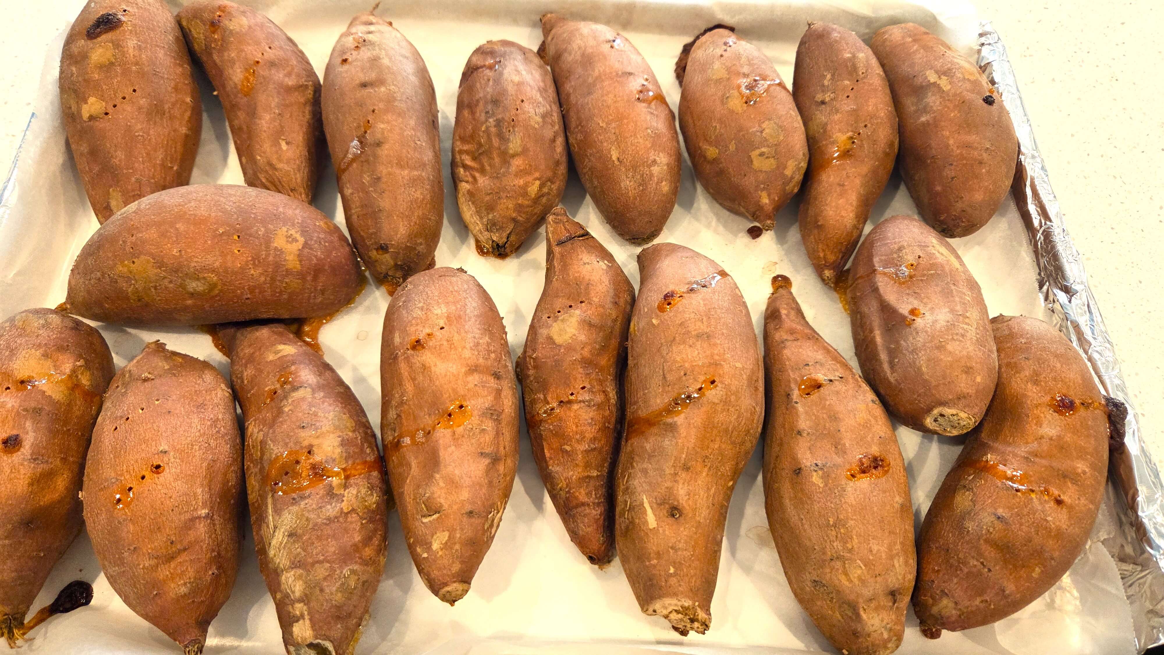Freshly Baked Sweet Potatoes on Foil Tray.