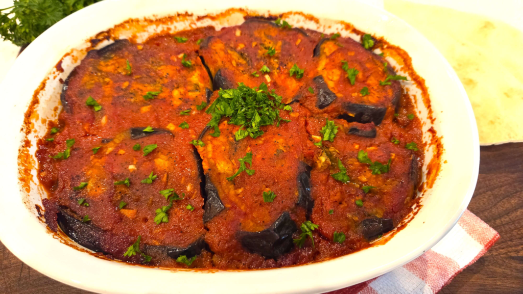 Authentic Egyptian moussaka with roasted eggplant, green bell peppers, ground beef, and tomato sauce.