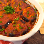 Egyptian moussaka with roasted eggplant, green bell peppers, ground beef, and tomato sauce.