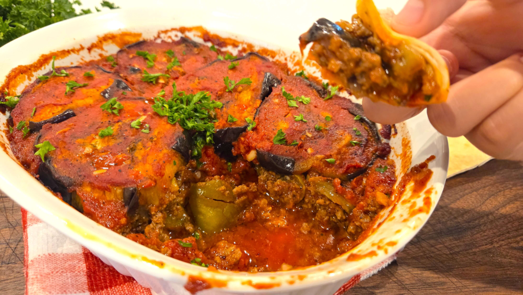 Layered Egyptian moussaka with tender roasted eggplant, green peppers, seasoned ground beef, and tomato sauce.