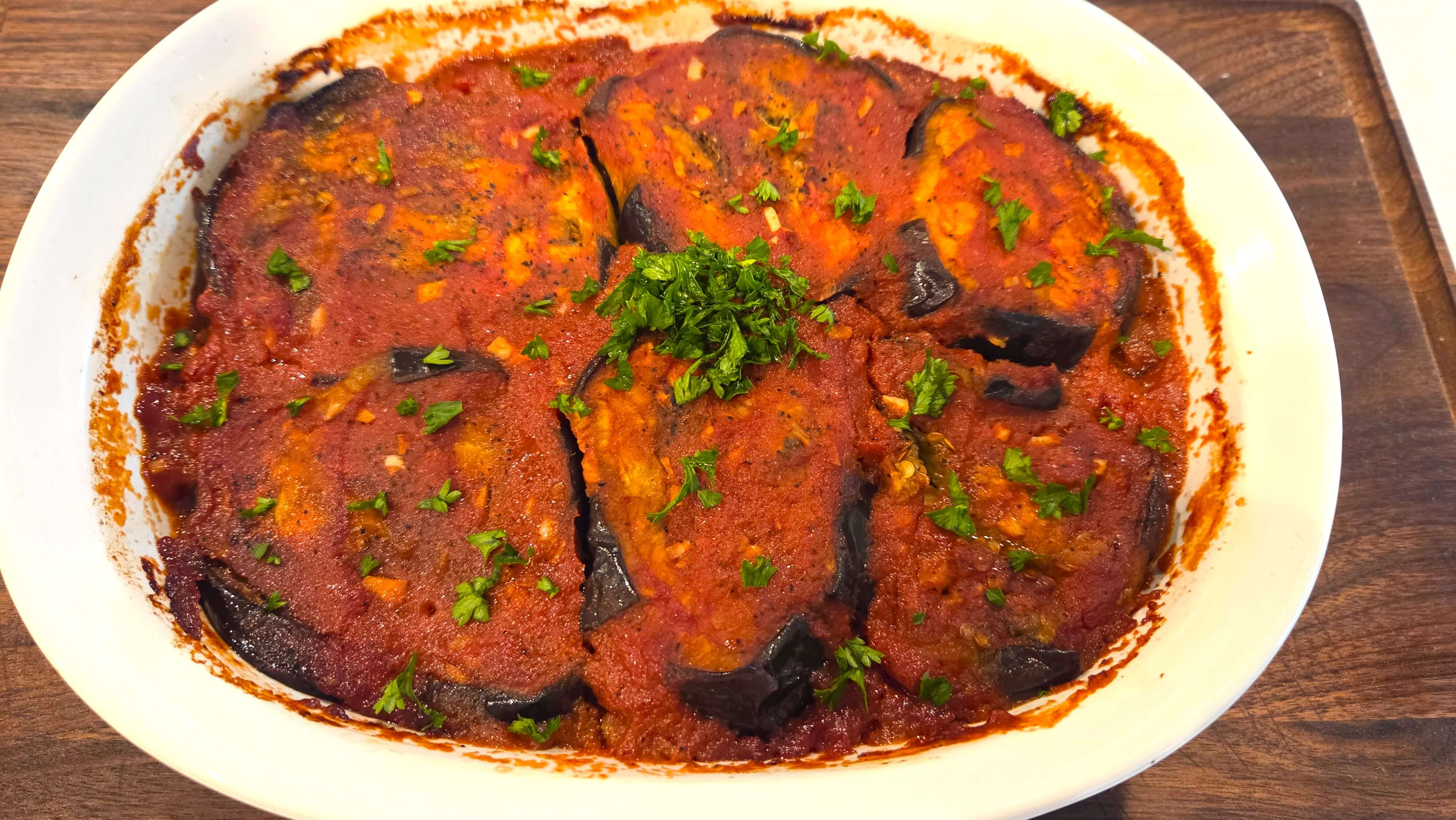 Warm Egyptian moussaka garnished with fresh parsley.