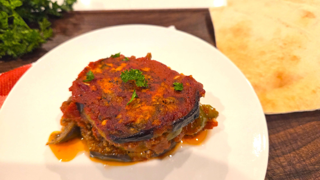 Egyptian moussaka served warm with pita bread and fresh parsley.