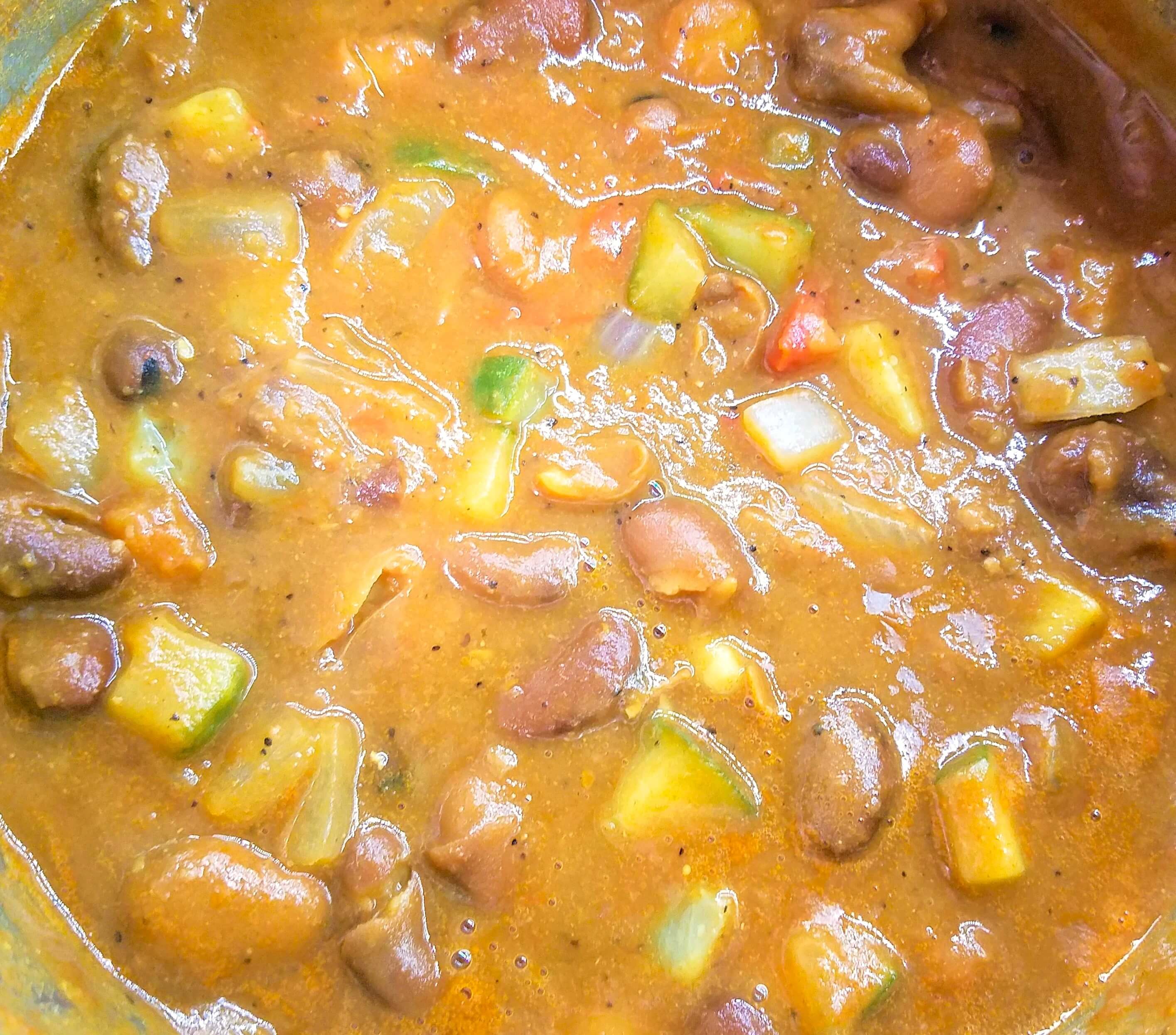 Egyptian Ful Medames dressed with lemon juice, garlic, tomatoes, cucumbers, and olive oil.