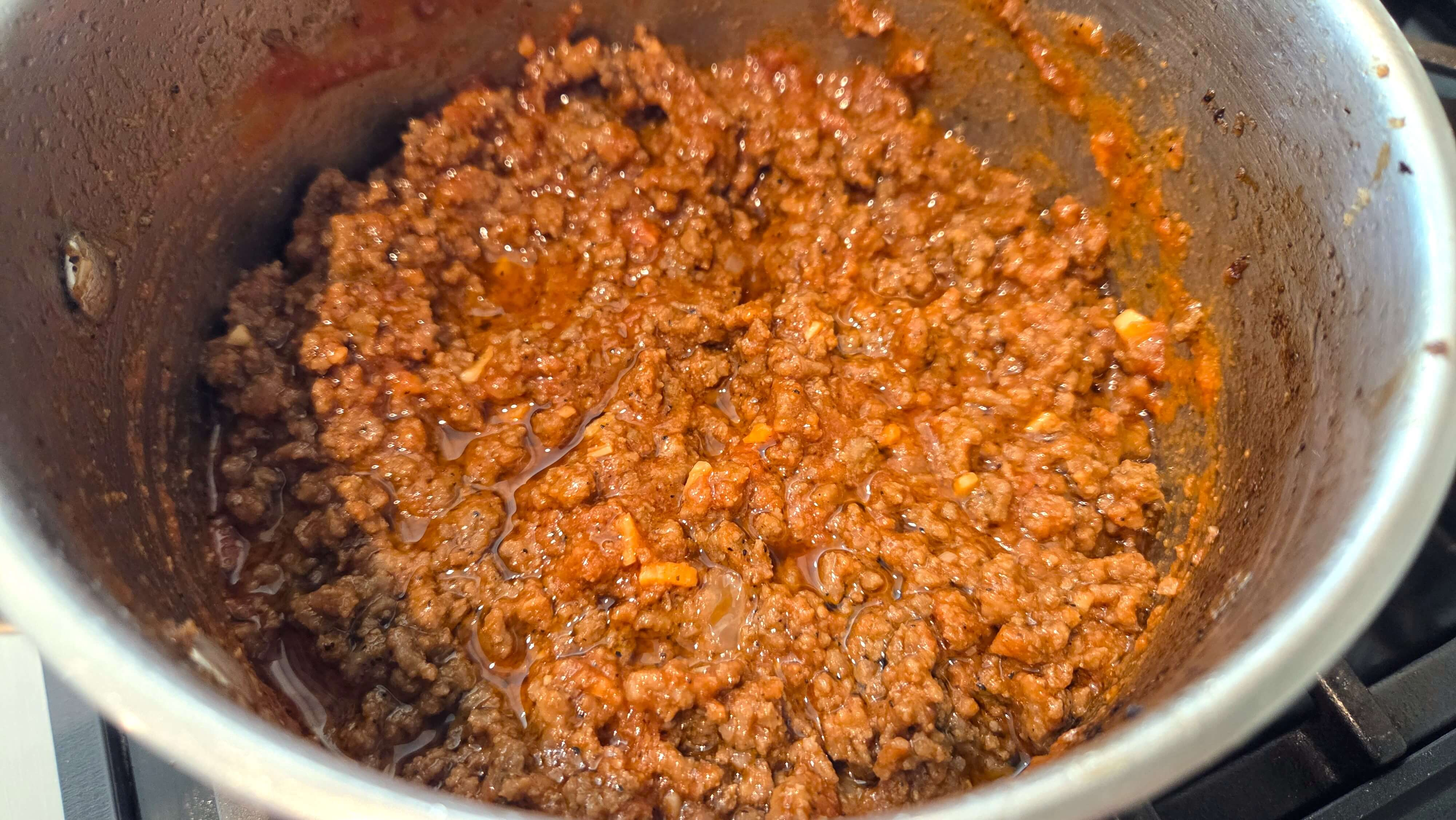 Tomato sauce stirred into browned ground beef and onions.