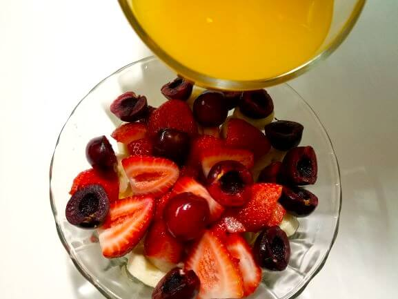 Mango juice poured over fresh fruit to make Egyptian Fakhfakhina.