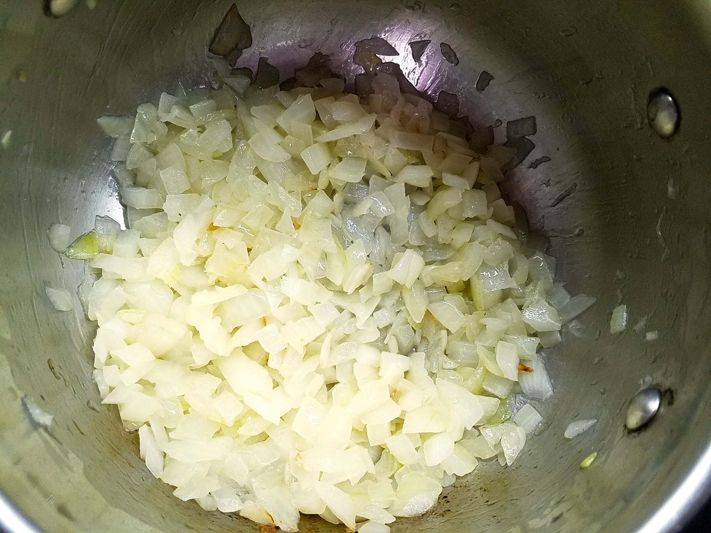 Diced onions sautéing in ghee for Bamya Bel Lahma