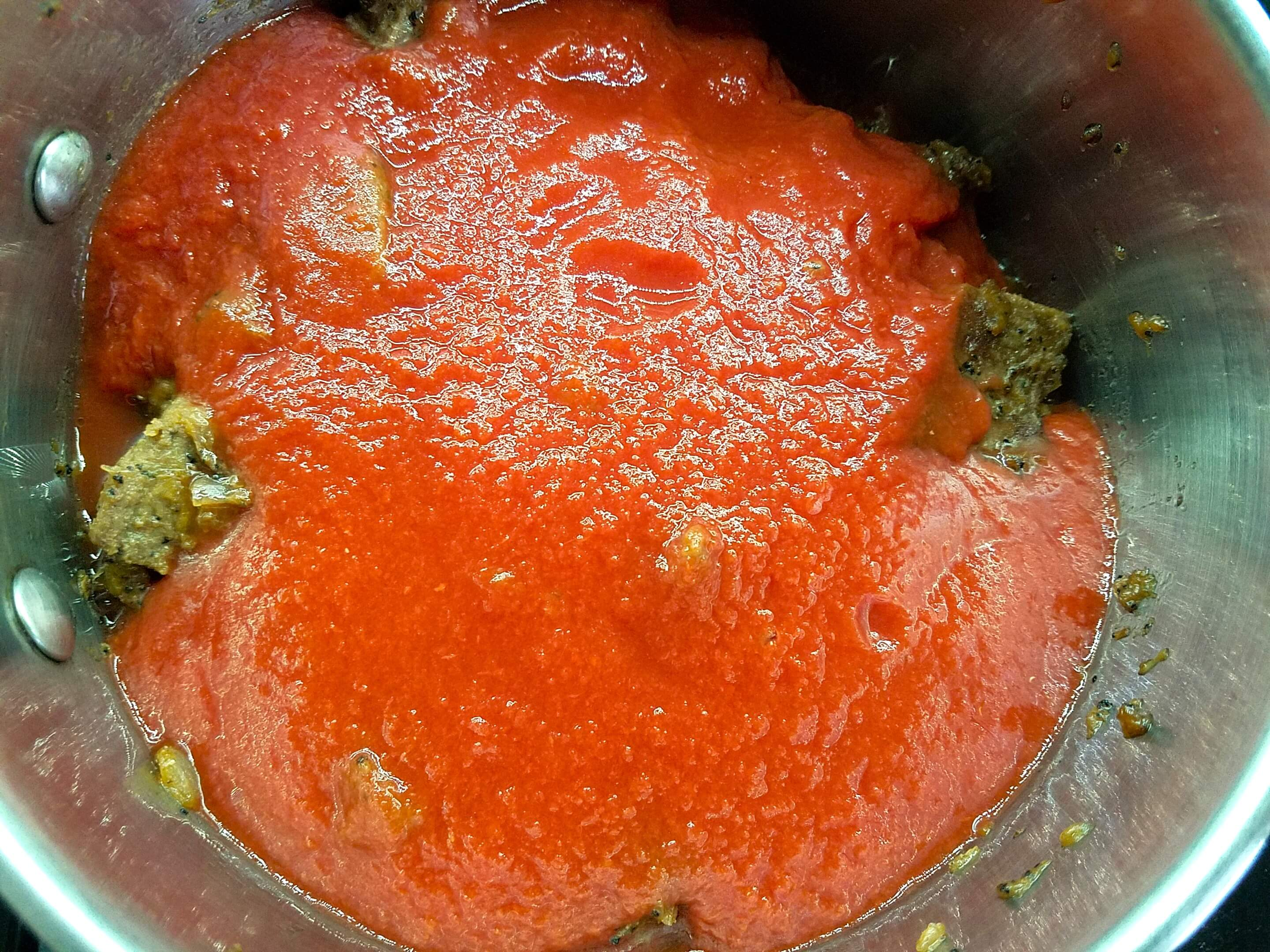 Tomato sauce added to browned beef
