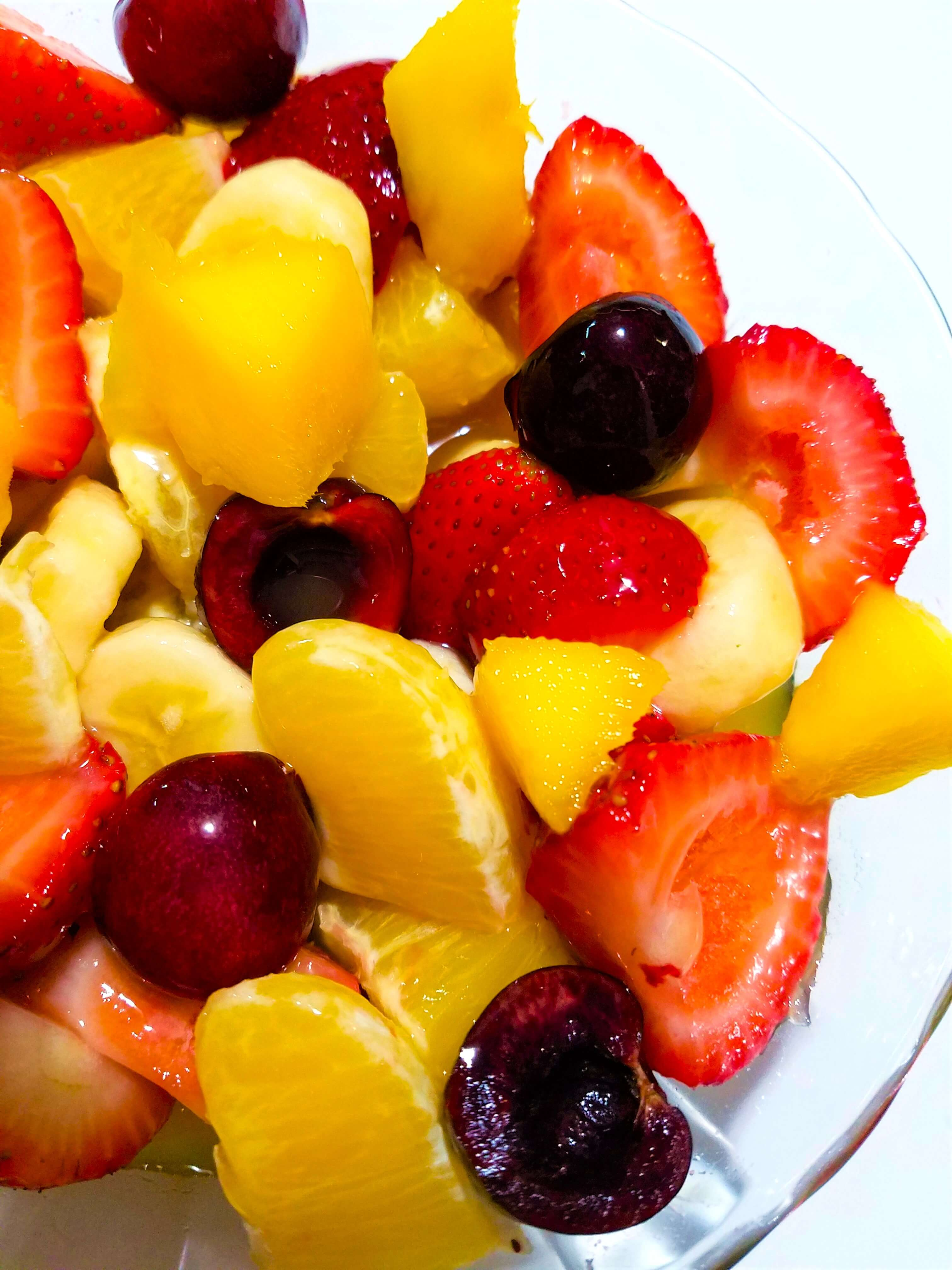 Fakhfakhina fruit salad with fresh mango, strawberries, oranges, cherries, banana, and mango juice.