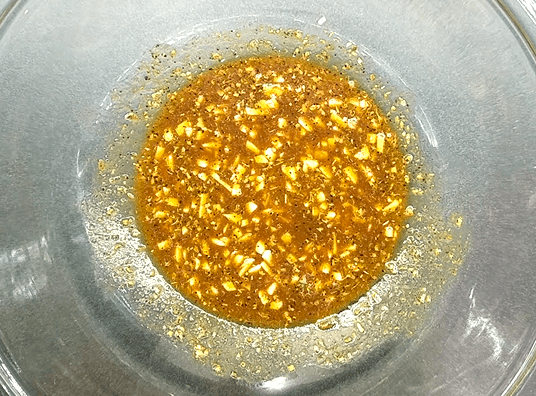 Garlic lemon marinade with olive oil and Mediterranean spices for grilled shrimp.