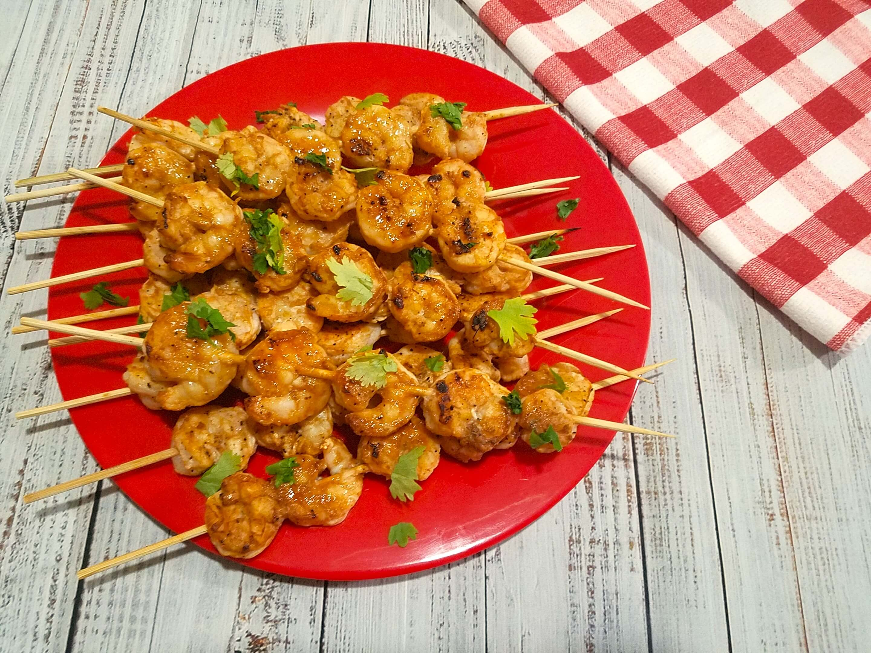Juicy grilled shrimp kabobs garnished with fresh parsley and ready to serve.