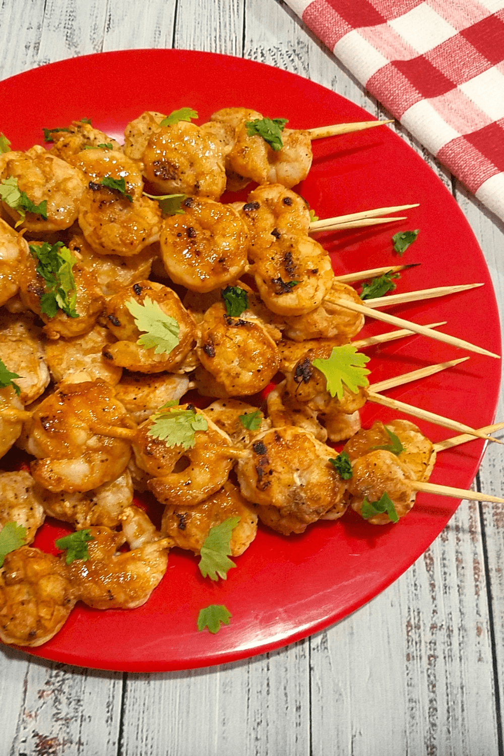 Grilled shrimp kabobs with lightly charred edges and fresh parsley.