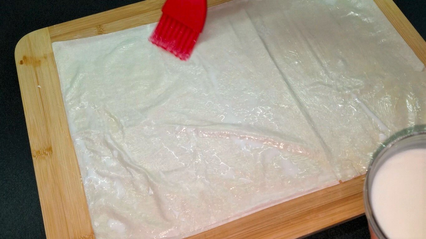 Two phyllo sheets layered and brushed with a butter and milk mixture