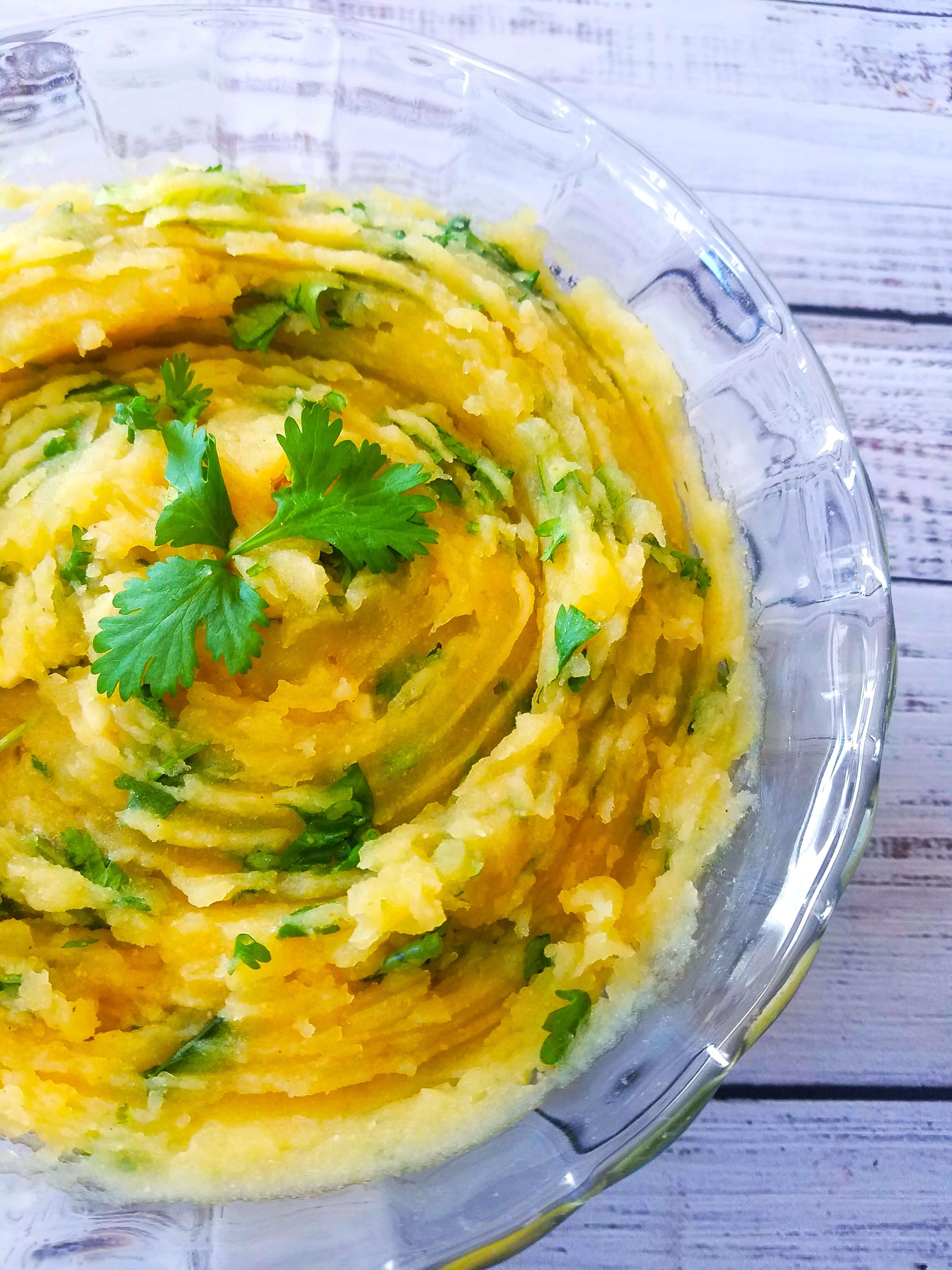 Easy mashed potato salad made with potatoes, lemon juice, cilantro, garlic, and olive oil.
